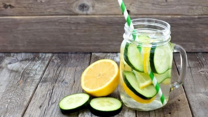 Water in mason jar with lemon and cucumber